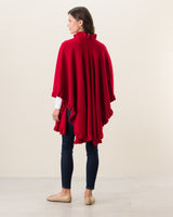 Woman Wearing Knitted Cashmere Cape in Red with jeans and flats