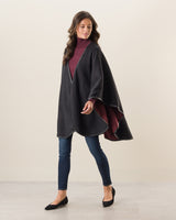 Woman Wearing Reversible Cashmere Cape with Leather trim in Deep Red/Charcoal
