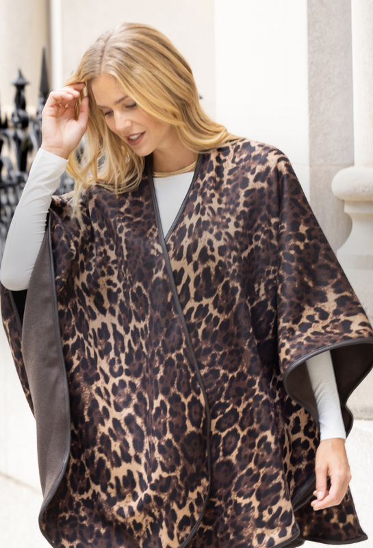 Woman wearing a leopard print cashmere cape in an urban setting