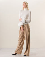 Woman wearing Cashmere Turtleneck with Finnish fur Cuffs in Ivory