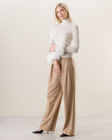 Woman wearing  Cashmere Turtleneck with Finnish fur Cuffs in Ivory