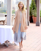 Woman in a sweater and skirt with a St Tropez lightweight cashmere wrap in Champagne