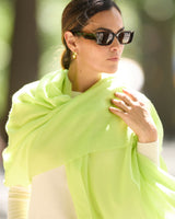 A woman outdoors  wearing CHARTRUESE st tropez wrap and sunglasses