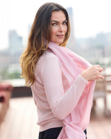 Model wearing St Tropez wrap in pink with a sweater, jeans and sunglasses, side view