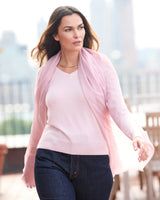 Model wearing St Tropez wrap in pink with a sweater, jeans and sunglasses on a rooftop