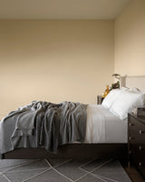 several Umbria cashmere throws on bed in Grey