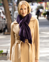 Woman wearing a  coat and Voyage Cashmere Wrap in Currant on a city street