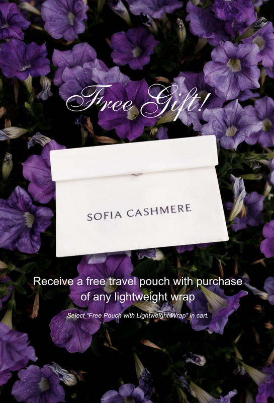 Sofia Cashmere travel pouch on a background of purple flowers with promotional text.